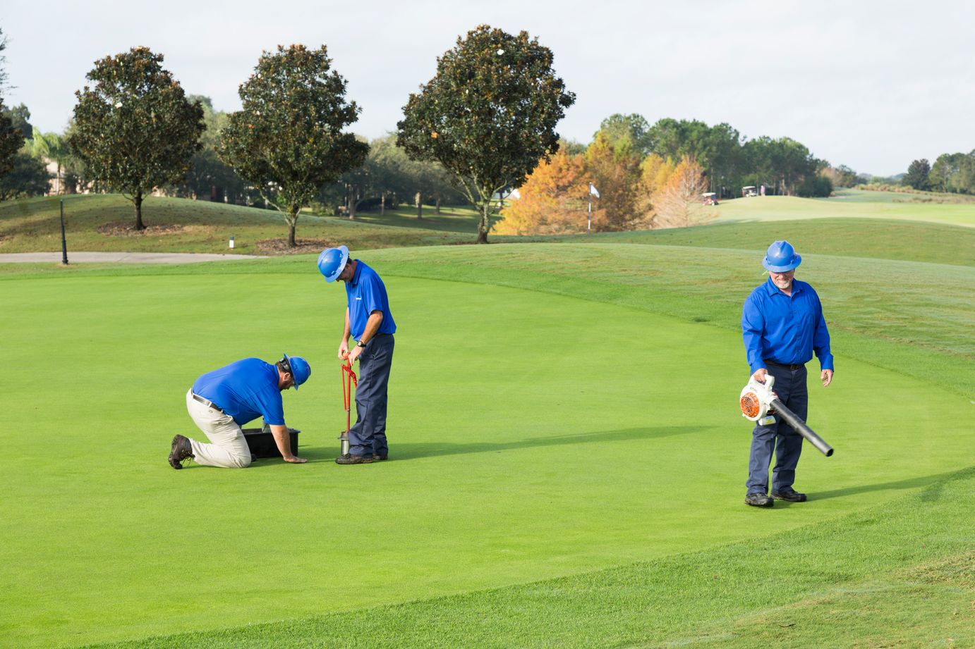 golf maintenance crew collecting a soil sample