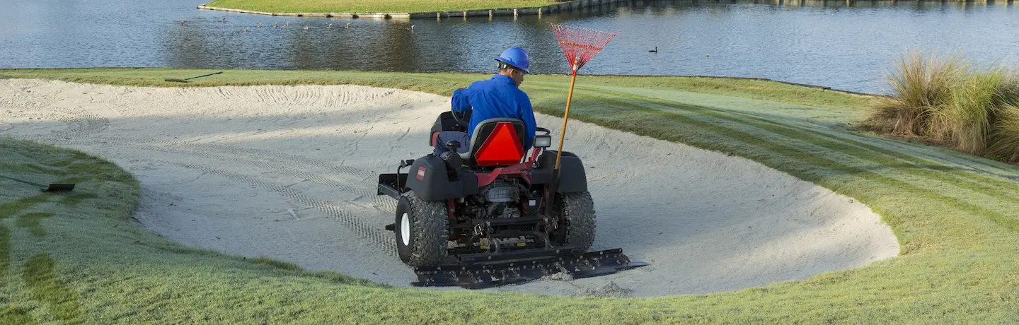 crew member operating bunker rake safely