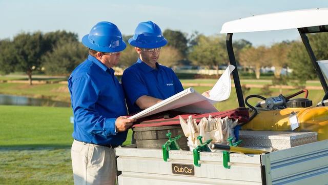 golf course maintenance crew discussing blue print