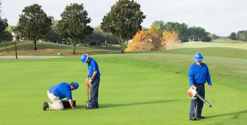 golf course maintenance crew collecting soil sample