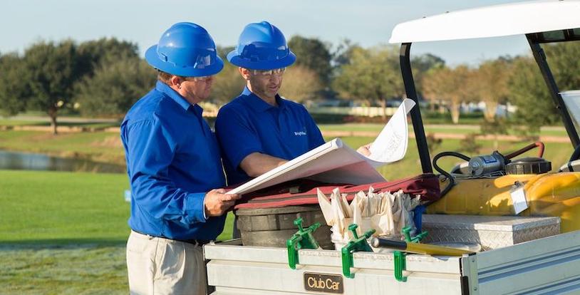 golf course maintenance crew discussing blue print
