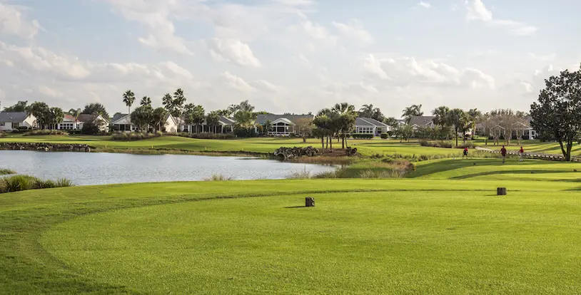 tee box on a golf course with water hazard in the background