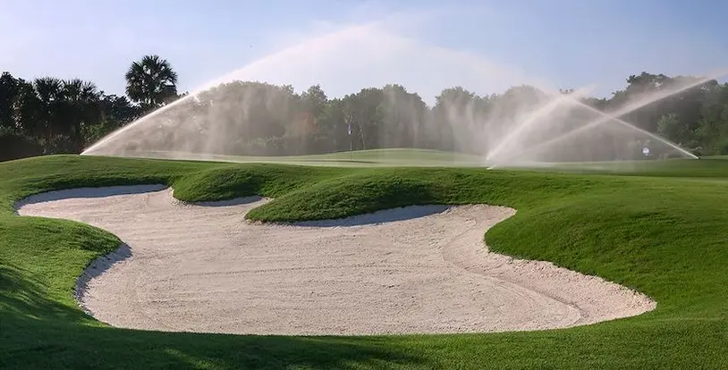 sprinklers watering a golf course