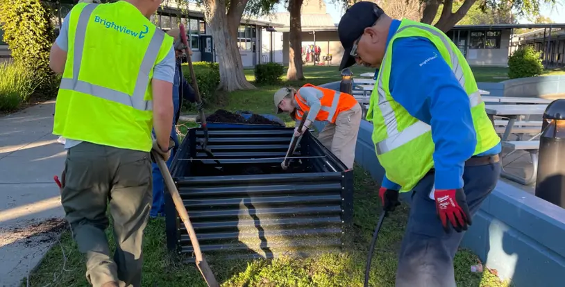 Theaurkauf Elementary School students BrightView garden beds
